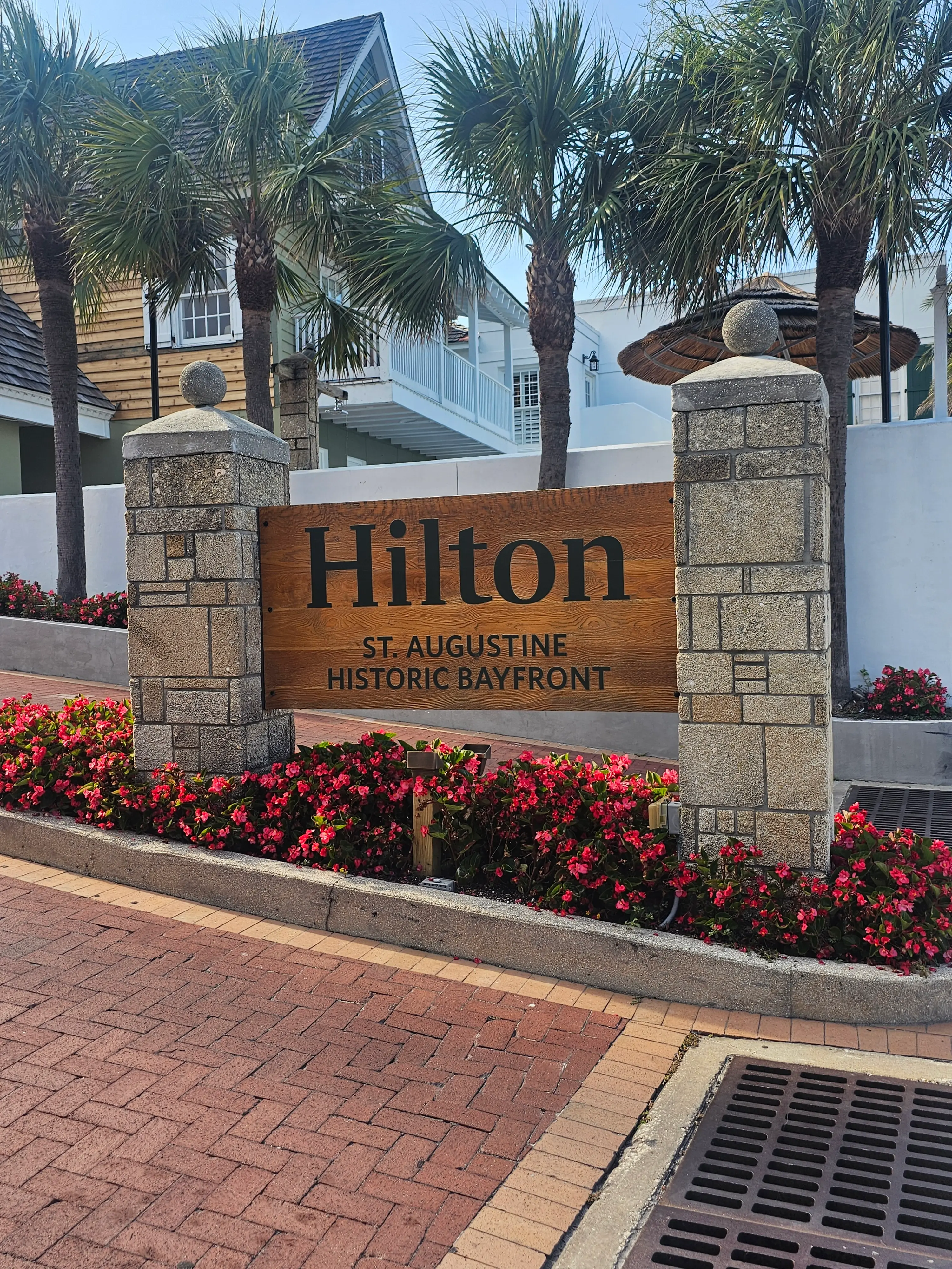 Brick-lined garden space with tropical plants and flowers at Hilton St. Augustine Historic Bayfront, offering guests a peaceful retreat in the heart of downtown St. Augustine Florida.