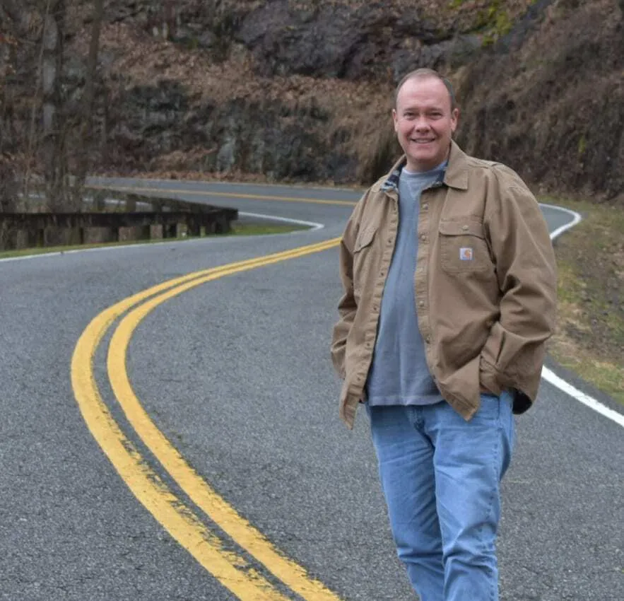 The Best Things to Do in Bryson City, NC 5 Steve Brown standing on the scenic Road to Nowhere in Bryson City, NC โ a popular stop featured in many travel guides on things to do in Bryson City NC.