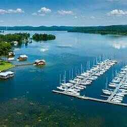 7 Fun Things to Do In Guntersville, AL Today 5 Boats docked at a marina on Lake Guntersville, Alabama, with peaceful water and surrounding hills—perfect for fishing, relaxing, and lakefront exploring.