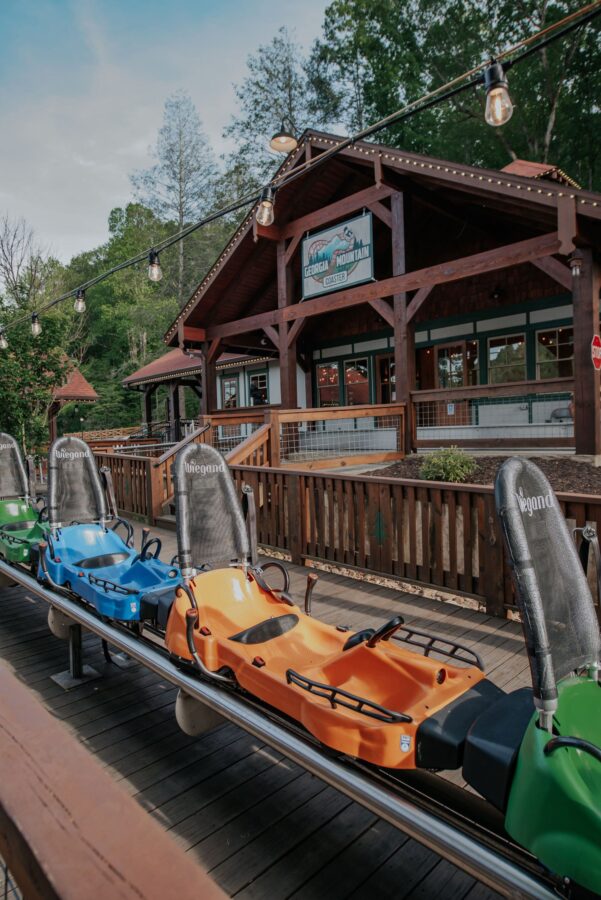 Helen Georgia's Top Attractions For 2025 6 Colorful alpine coaster carts lined up outside the Georgia Mountain Coaster station in downtown Helen GA.