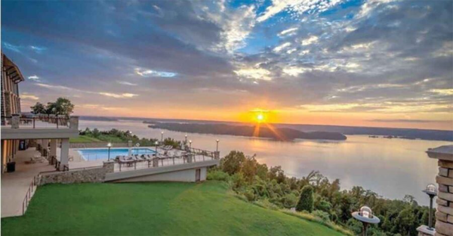 7 Fun Things to Do In Guntersville, AL Today 6 Golden sunset over Lake Guntersville State Park with a view of the lodge, rolling hills, and calm lake waters—one of the top attractions in Guntersville, AL.