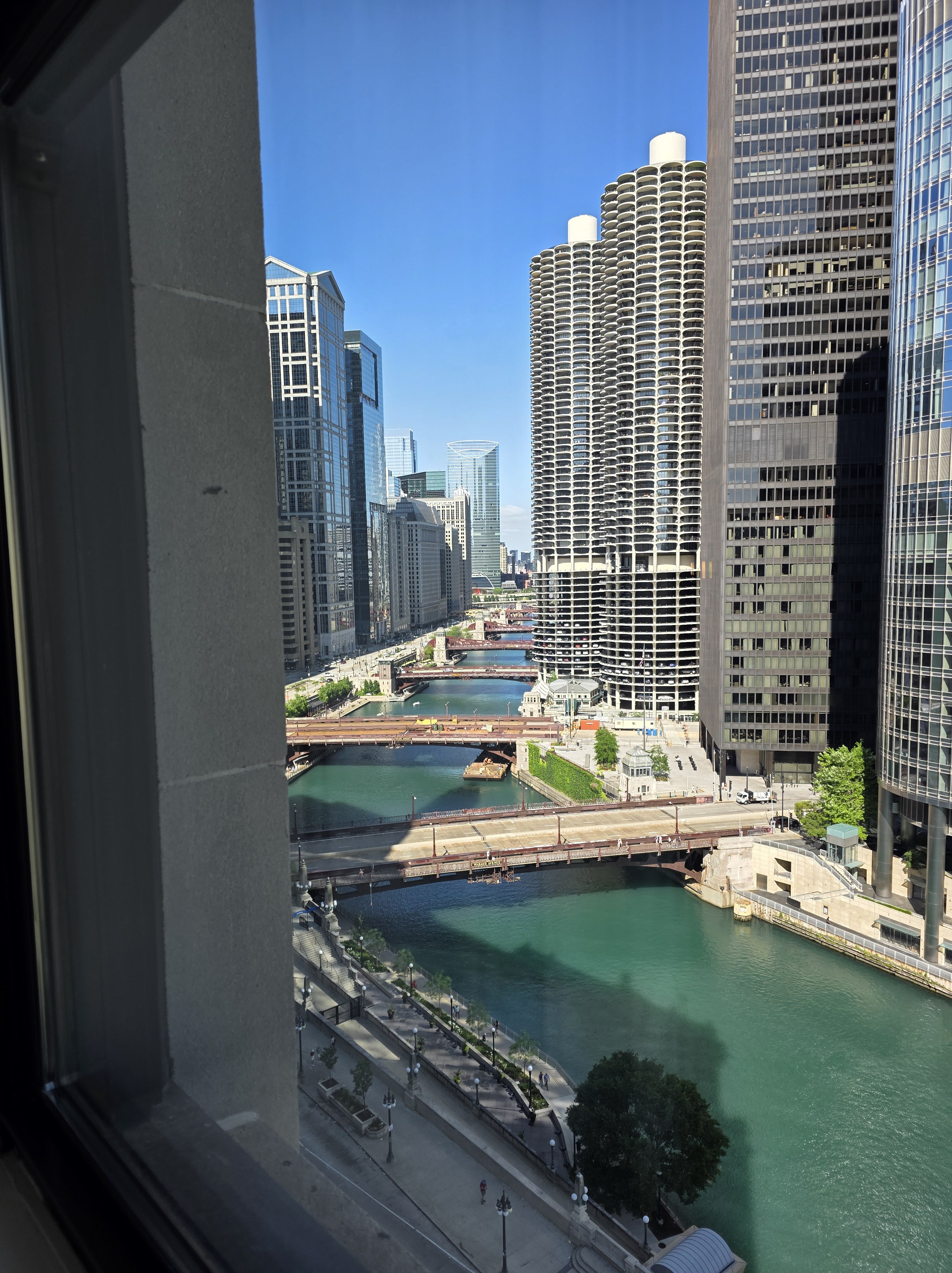Easy Guide to The Chicago Water Taxi Stops 2 Stunning view of the Chicago River and Marina City from a high-rise window, showcasing downtown Chicago's skyline and water taxi route.